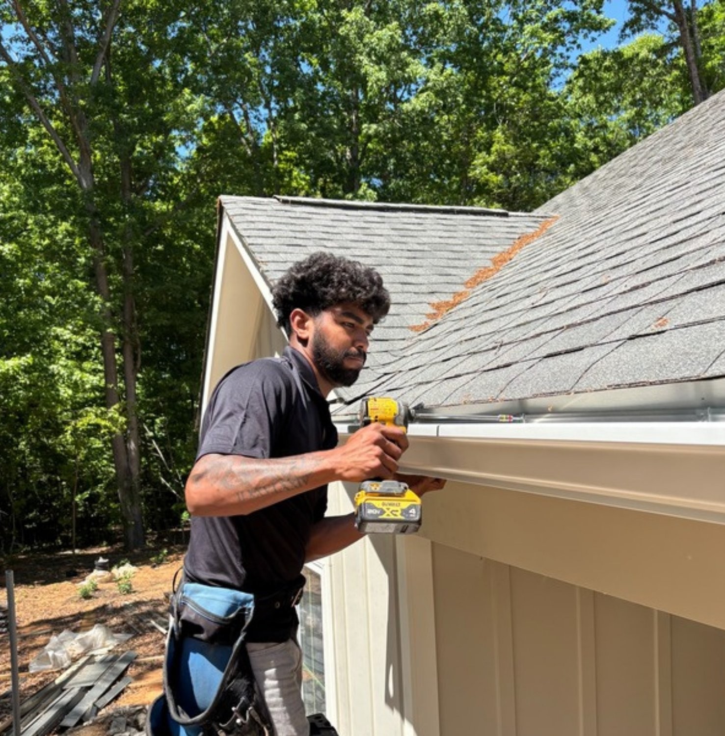 J&R Gutters crew installing a seamless gutter